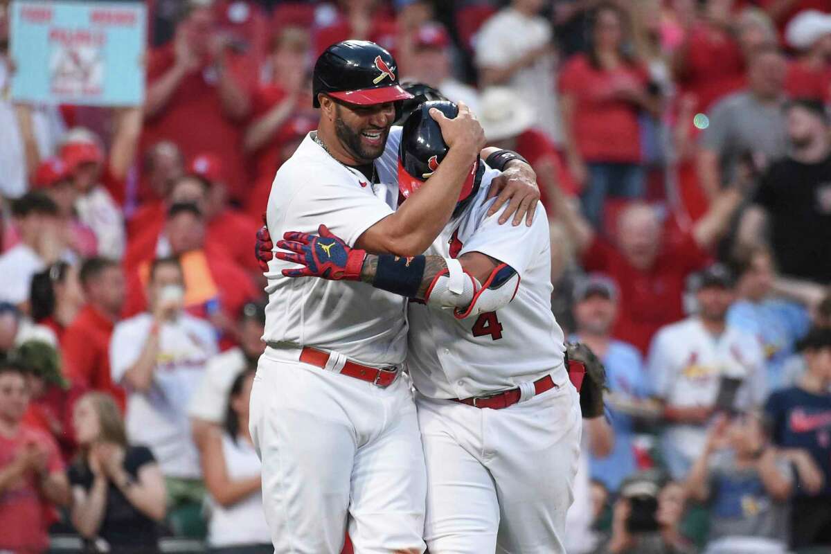 St. Louis Cardinals' Yadier Molina (4), right, celebrates with teammate Albert Pujols after hitting a two-run home run during the fifth inning of a baseball game against the San Francisco Giants on Sunday, May 15, 2022, in St. Louis. (AP Photo/Joe Puetz)
