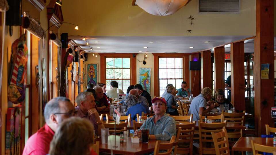 People sit down for lunch at Mosquito Cafe, Wednesday, May 11, 2022, in Galveston.