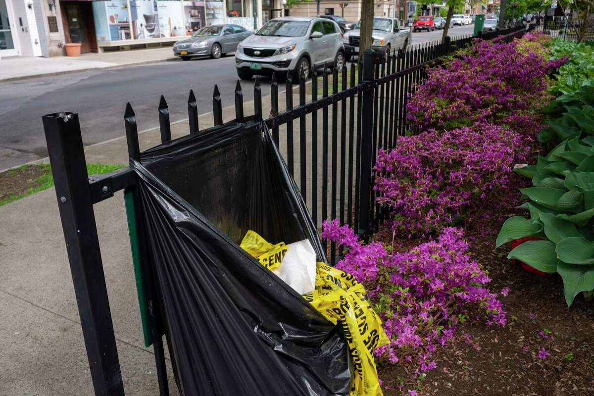 Crime scene tape is seen bundled up in a garbage bag not far from the intersection of Third St. and State St. on Monday, May 16, 2022, in Troy, N.Y. One man is dead and another man was wounded in a stabbing in this area. (Paul Buckowski/Times Union)