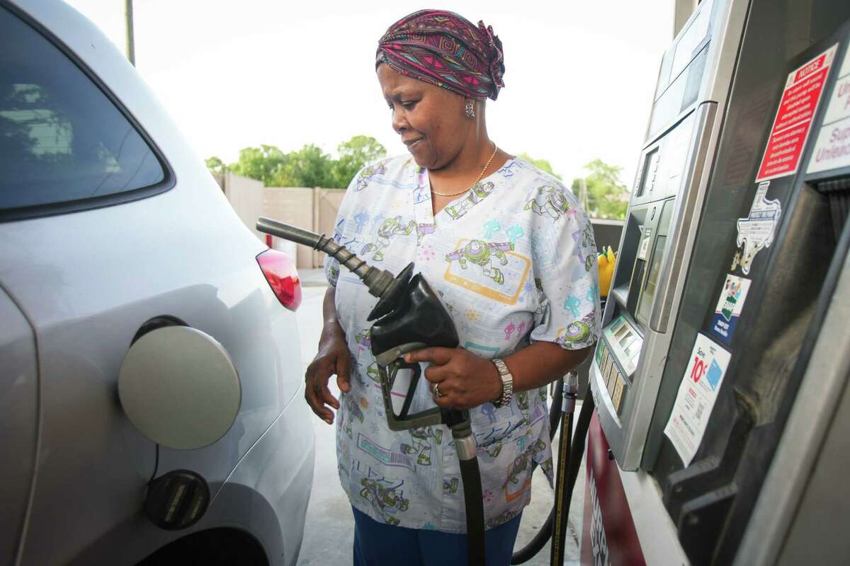 Mary James gets ready to pump gas into her vehicle Monday, May 16, 2022 in Houston. Average Houston gas prices leap above $4 a gallon for first time, setting record high.