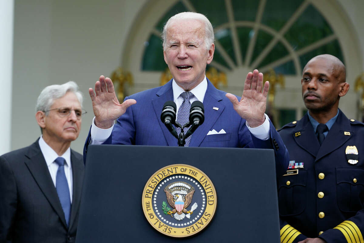 President Joe Biden speaks in the Rose Garden of the White House in Washington, Friday, May 13, 2022, during an event to highlight state and local leaders who are investing American Rescue Plan funding. Attorney General Merrick Garland, left, and Kansas City, Mo., Police Department Police Chief Joe Mabin listen. (AP Photo/Susan Walsh)