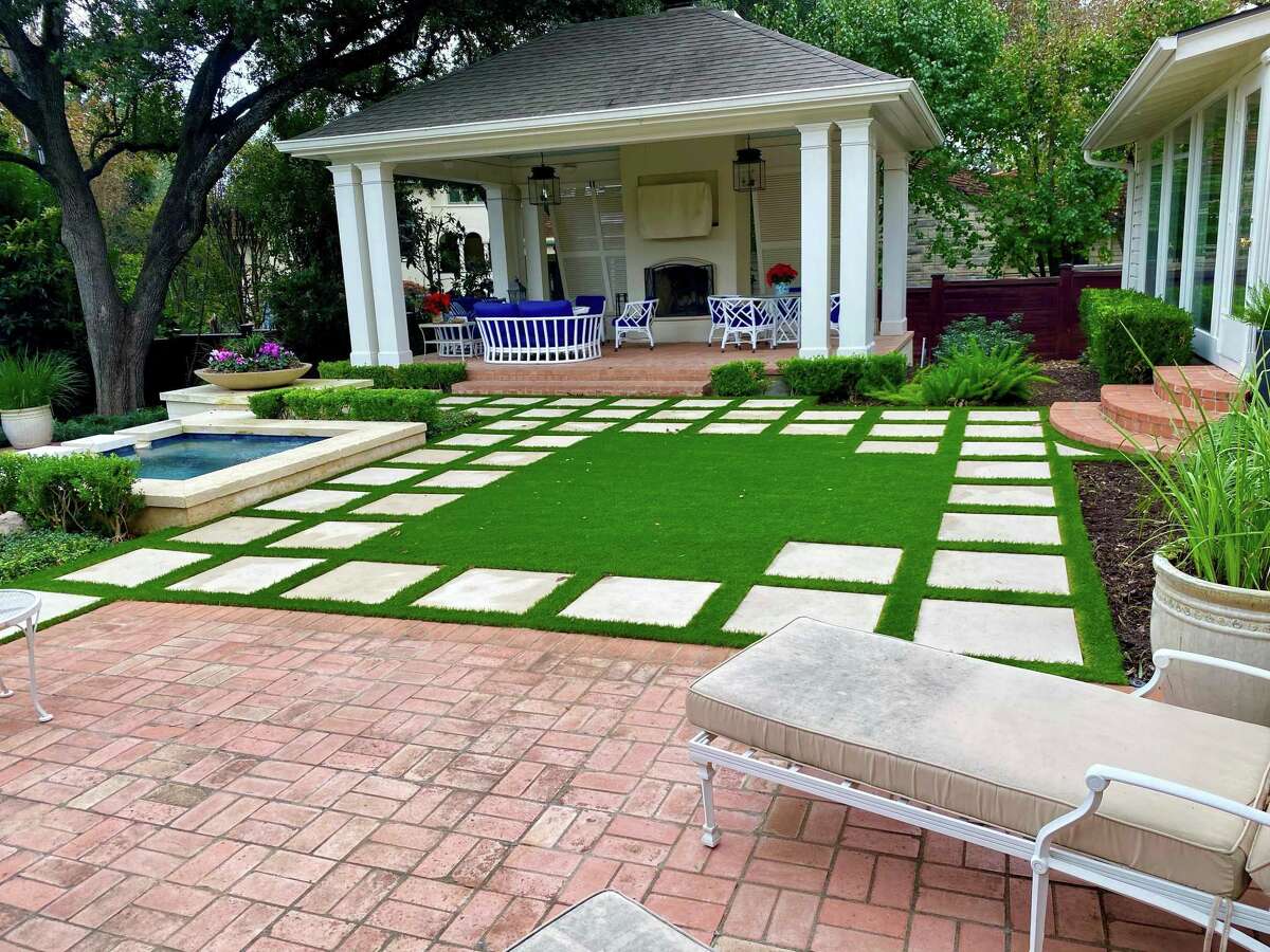 For this house, Justin Hale, owner of Amazing Turf & Lawn, replaced old pavers and turf grass with new pavers and artificial turf.