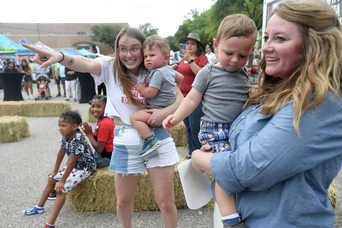 Best friends Amber Hinson (left) and Rebecca. Schexnyder dance with their sons Tobias Hinson and Judah Schexnyder during Viva Artaco Hispanic Heritage Festival in Beaumont Saturday. Photo made Saturday, May 14, 2022. Kim Brent/The Enterprise