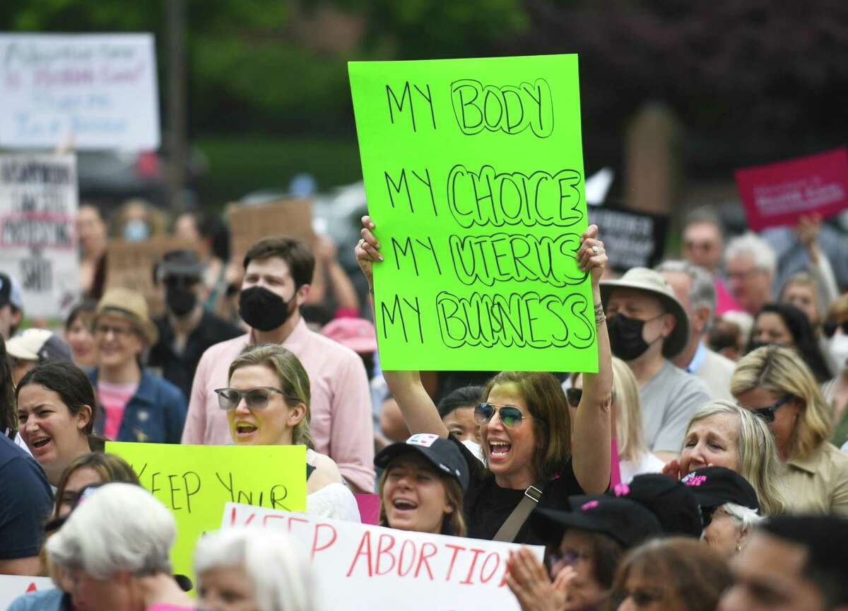 Stamford’s Robbin Ashenfelter holds a sign during the Bans Off Our Bodies rally outside state Superior Court in Stamford Sunday.
