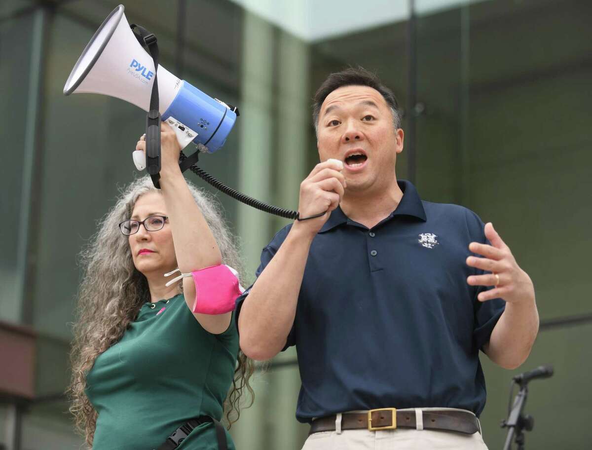 Connecticut Attorney General William Tong speaks as Pink Wave Action event organizer Shira Tarantino holds the megaphone during the Bans Off Our Bodies rally outside the Connecticut Superior Court in Stamford , Conn. Sunday, May 15, 2022. A collection of activist groups including Planned Parenthood Federation of America, Pink Wave Action, Women's March, Ultraviolet, and MoveOn were joined by Connecticut Lt. Gov. Susan Bysiewicz, Connecticut Attorney General William Tong, and other local leaders to rally for abortion rights.