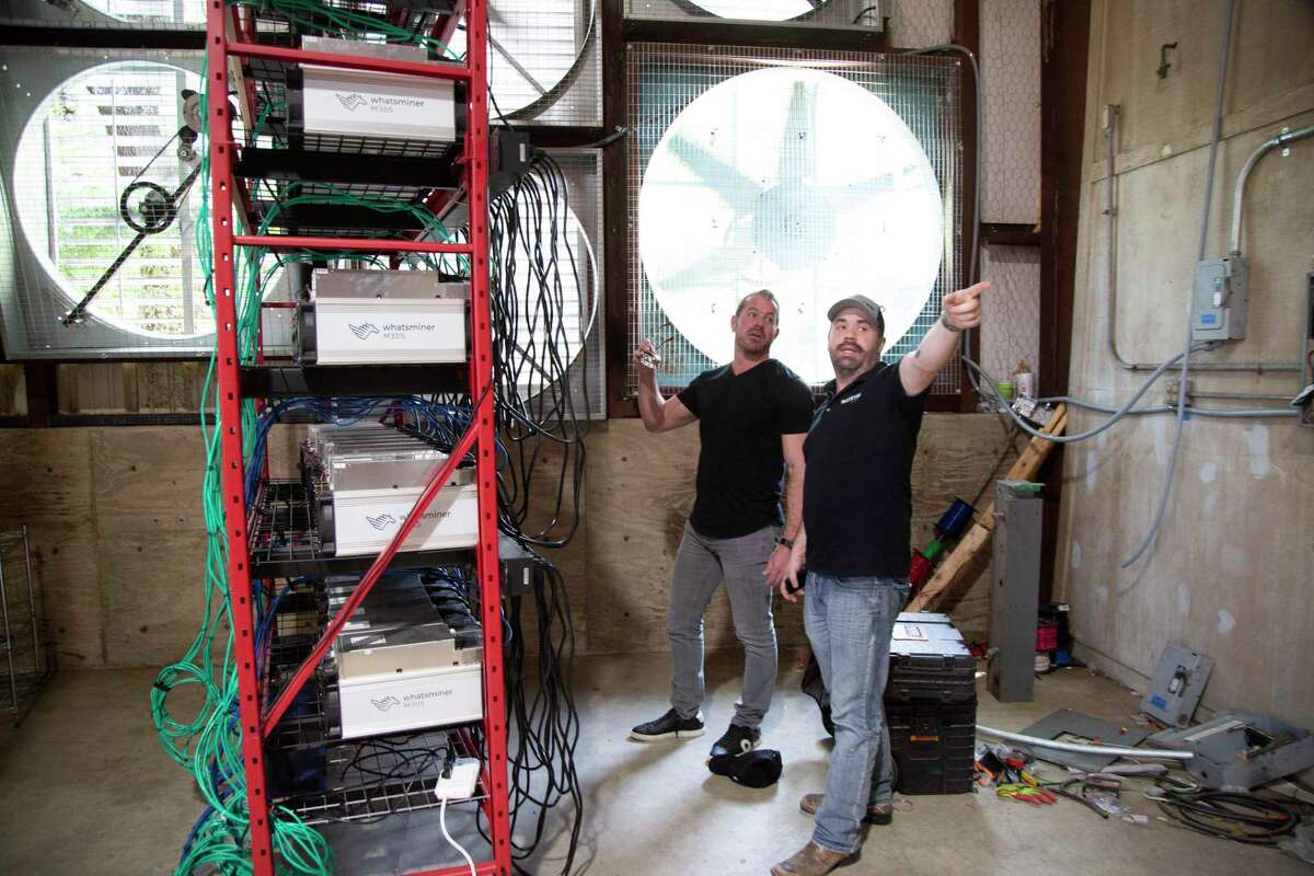 Caleb Ward, left, president and CEO at Geosyn Mining, and his partner Jeremy McNutt, prepare to install more crypto miners at their warehouse location northwest of Fort Worth, on Saturday, March 14, 2022. Founded by Caleb Ward and Jeremy McNutt, two oil and gas industry veterans, Geosyn Mining began operations in January 2022. These Texas entrepreneurs envision their company leveraging the power of Bitcoin to help proliferate solar energy production. (Joyce Marshall/for the Chronicle)