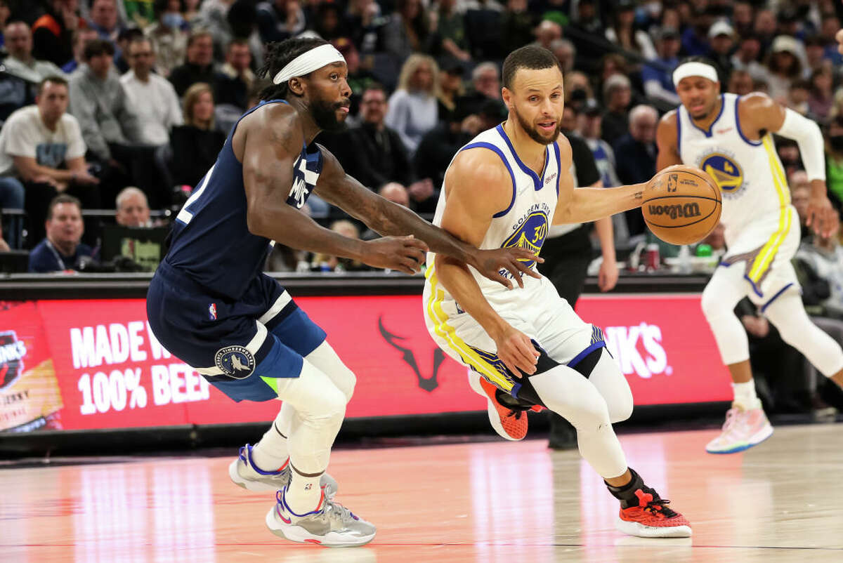 Stephen Curry of the Golden State Warriors drives to the basket while Patrick Beverley of the Minnesota Timberwolves defends on March 1, 2022.