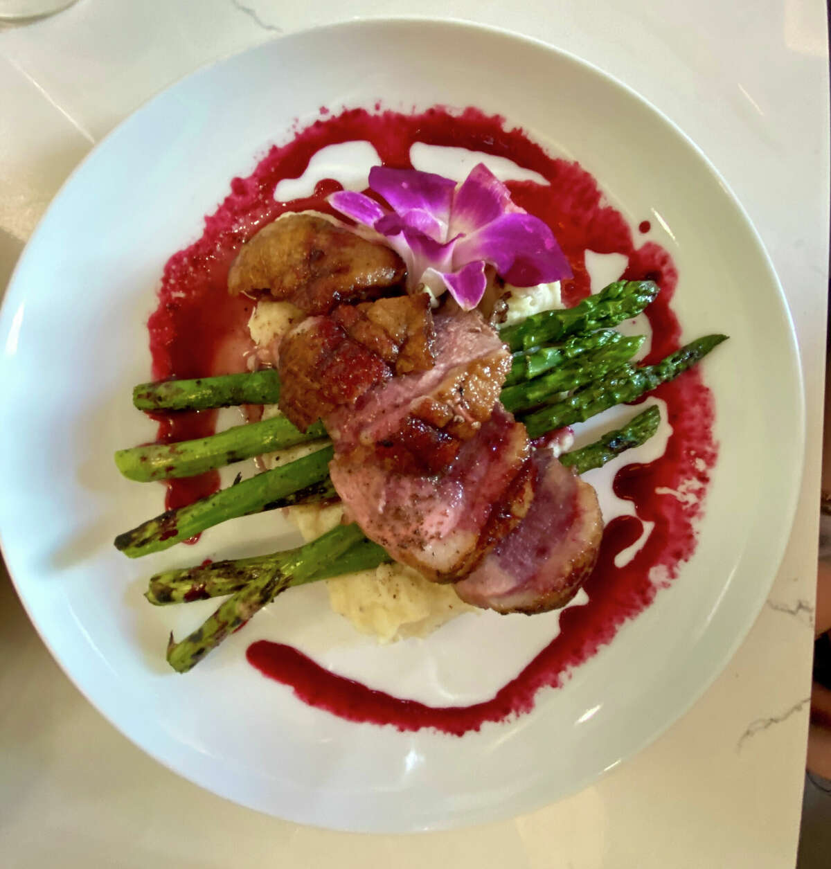 Seared duck with asparagus, mashed potatoes and blackberry reduction at Mint in Glens Falls, opened by the family that ran the former Sweet Beet Bistro in Greenwich.