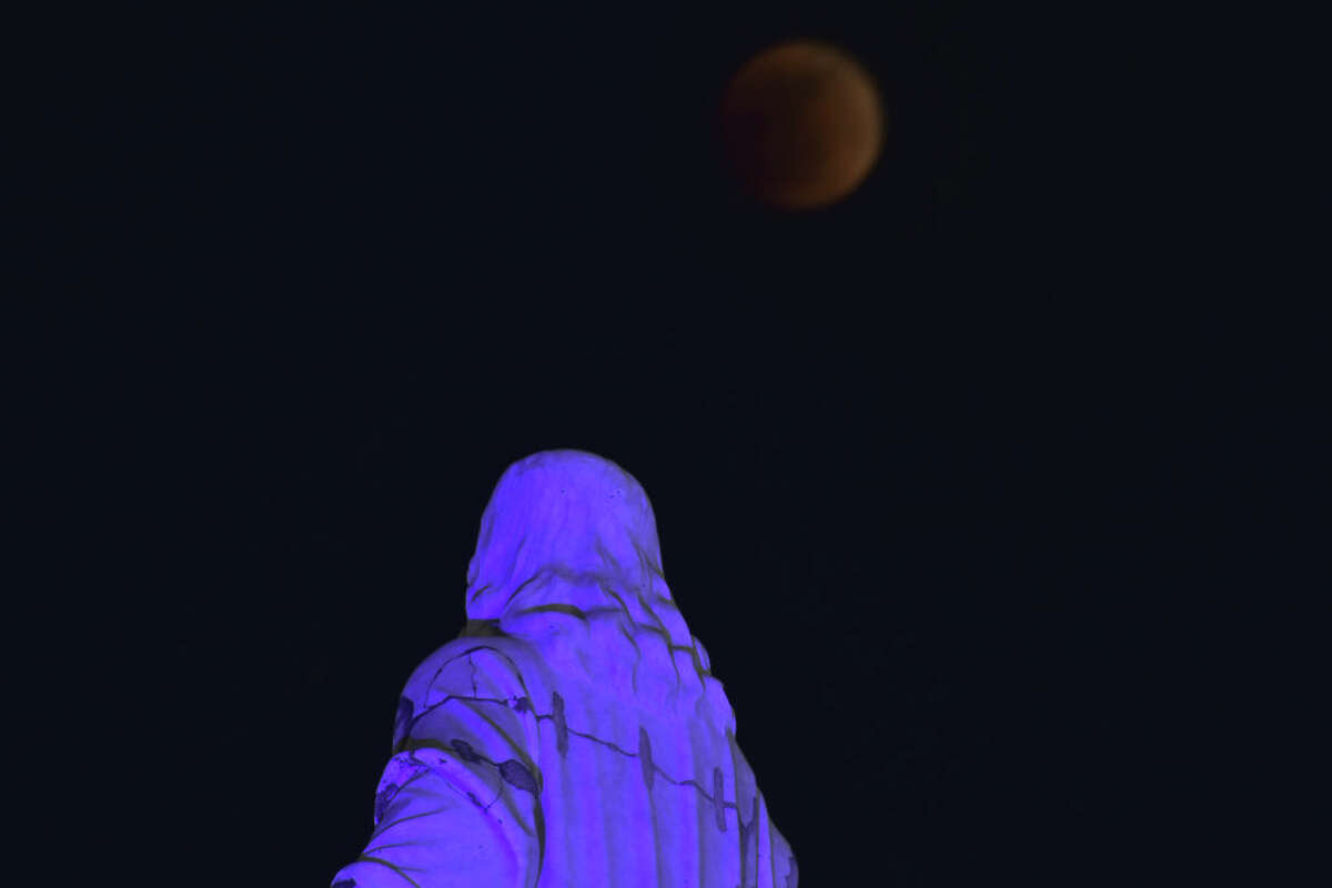 San Salvador, El Salvador: View of the Salvador del Mundo monument next to the moon.