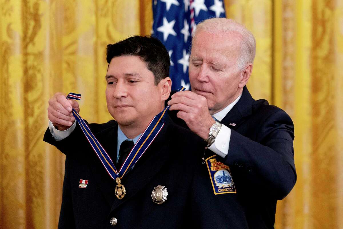 President Joe Biden awards Stamford Firefighter Michael Rosero the Public Safety Officer Medal of Valor in the East Room of the White House.