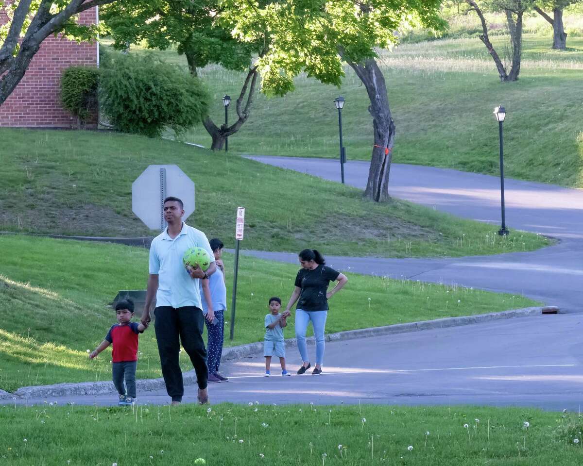 Pruthvi Mekala takes a walk with his family through the Park Hill apartment compext in Menands on Friday, May 13, 2022. (Jim Franco/Special to the Times Union)