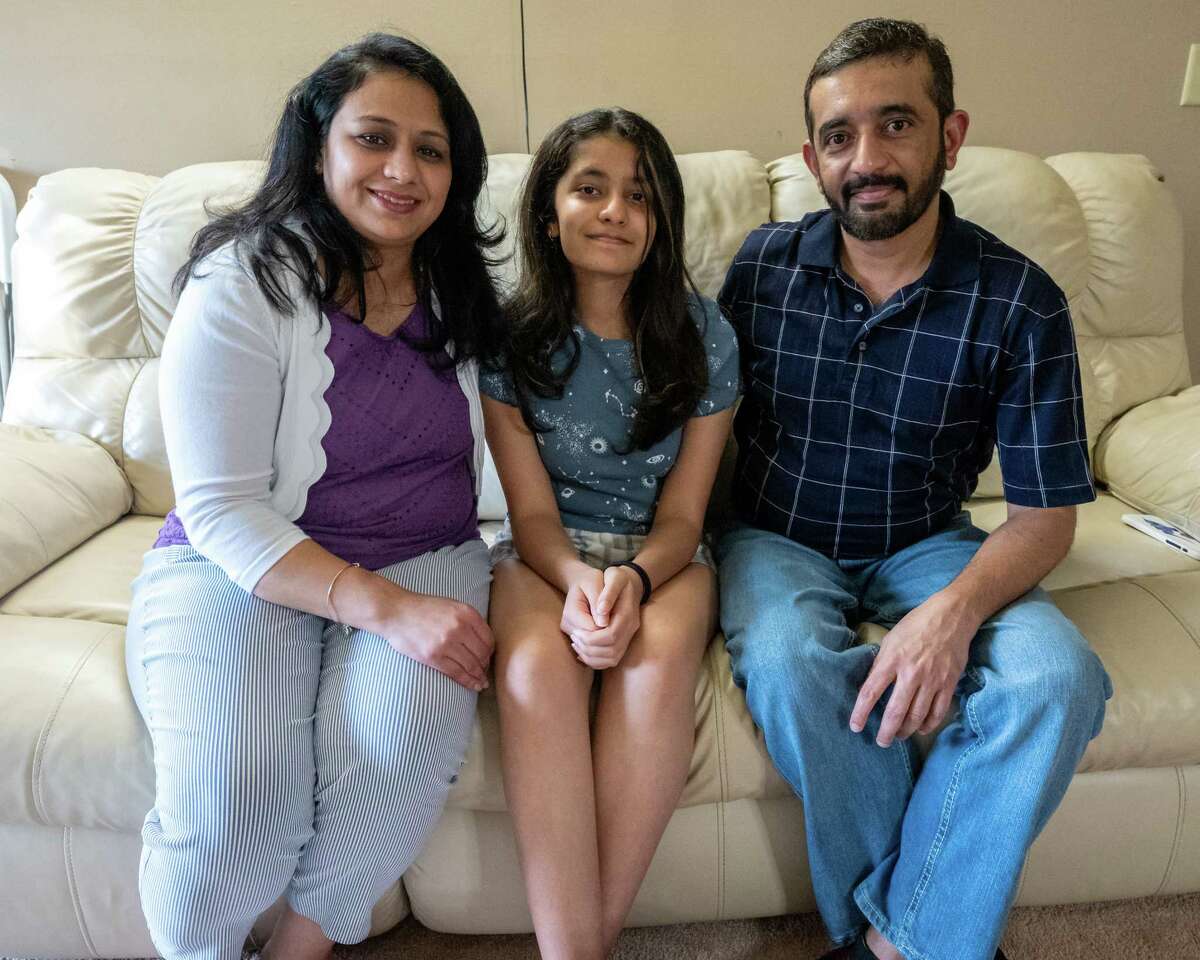 (from left) Suchita, Sanvi and Amol Jaju pose for a photo in their Park Hill apartment in Menands on Friday, May 13, 2022. (Jim Franco/Special to the Times Union)