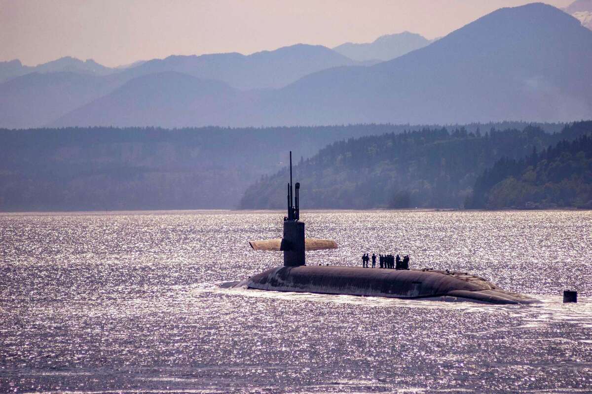 The Ohio-class ballistic missile submarine USS Louisiana transits Puget Sound in 2018. The Department of Defense is requesting $2.4 billion to help Electric Boat, Newport News Shipbuilding and their suppliers train workers to build the new Columbia class of ballistic missile subs, as well as attack subs. (U.S. Navy photo by Lt. Cmdr. Michael Smith/Released)