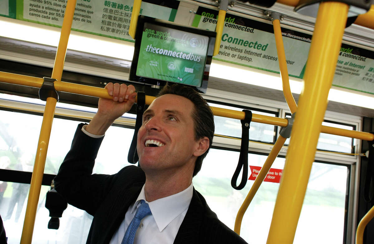 Then-San Francisco Mayor Gavin Newsom inspects the Connected Bus, a bus with high-tech features, on Feb. 20, 2008, in San Francisco.
