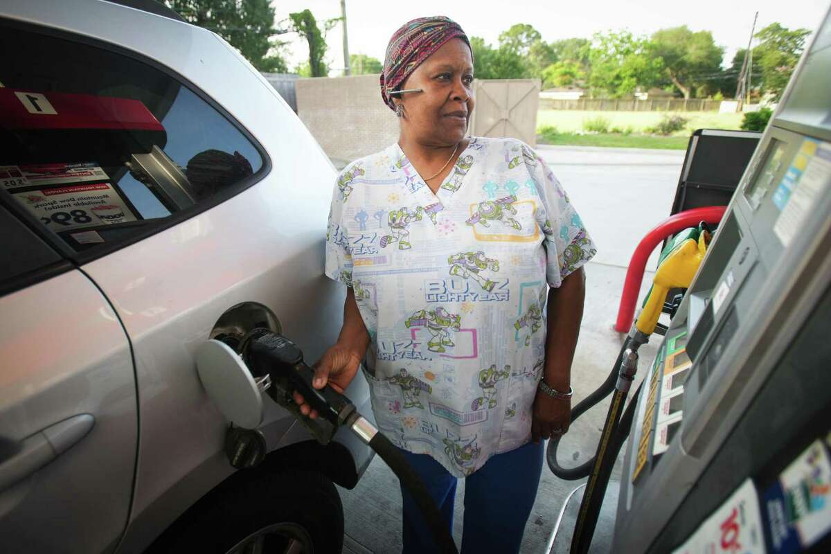 Mary James pumps gas into her vehicle Monday, May 16, 2022 in Houston. Average Houston gas prices leap above $4 a gallon for first time, setting record high.