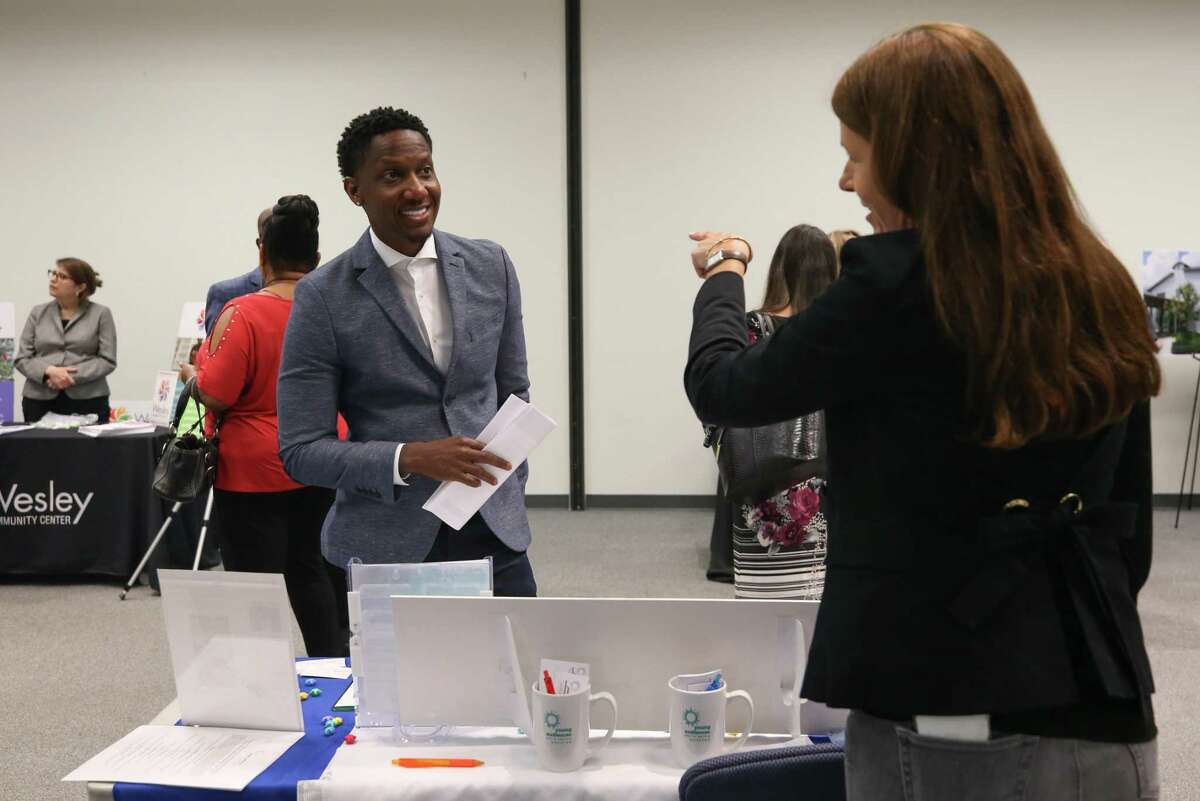 Warren Broadnax, left, speaks with a representative of Young Audiences Arts for Learning Houston, during the annual United Way job fair on Wednesday, May 11, 2022, in Houston. Broadnax will be graduating from United Way’s Project Blueprint, which trains people on how to become board members for organizations.