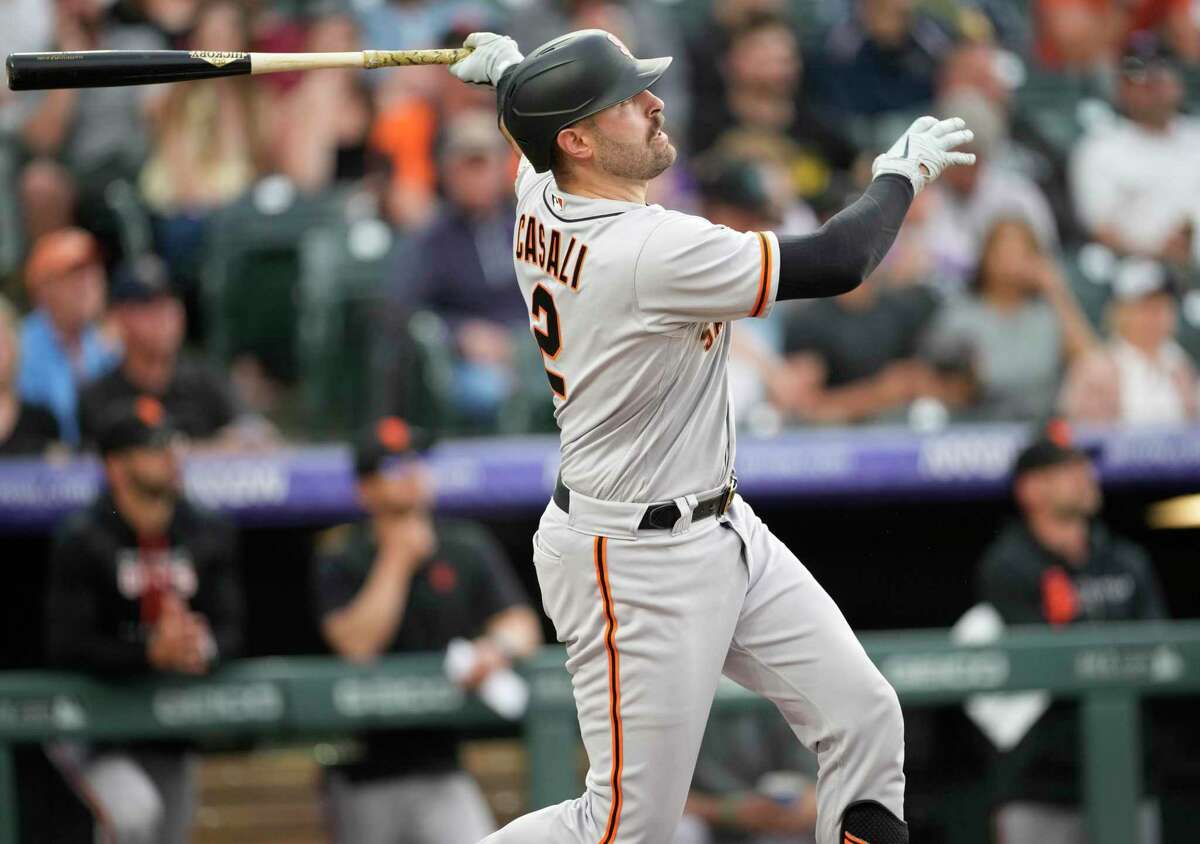 San Francisco Giants' Curt Casali follows the flight of his solo home run off Colorado Rockies relief pitcher Ty Blach in the third inning of a baseball game, Monday, May 16, 2022, in Denver. (AP Photo/David Zalubowski)