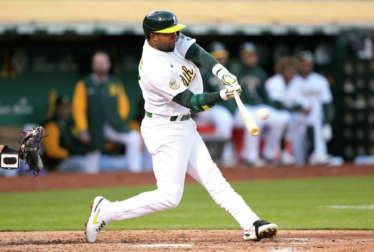 OAKLAND, CALIFORNIA - MAY 16: Elvis Andrus #17 of the Oakland Athletics hits an RBI double scoring Seth Brown #15 against the Minnesota Twins in the bottom of the fourth inning at RingCentral Coliseum on May 16, 2022 in Oakland, California. (Photo by Thearon W. Henderson/Getty Images)