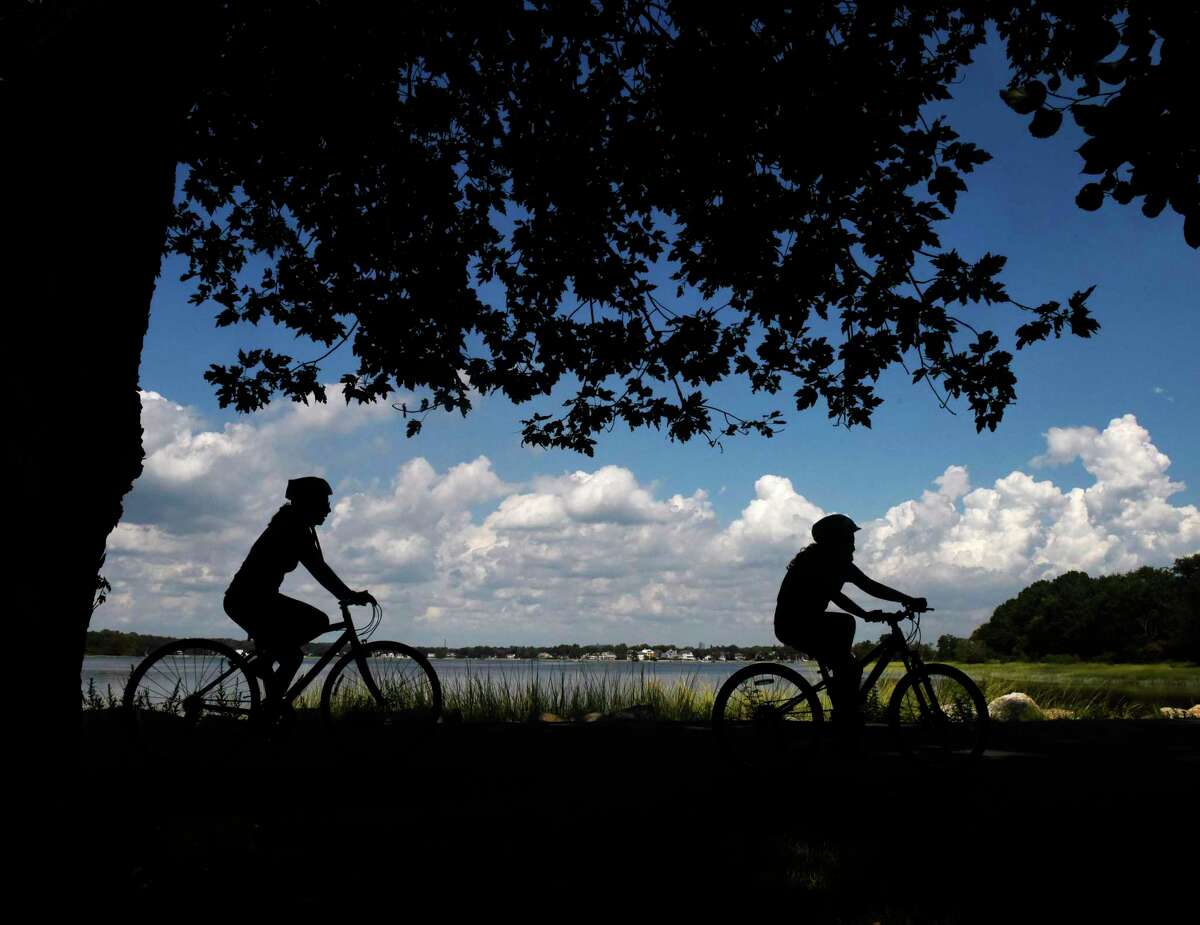 Cyclists go for a ride along the Tod's Driftway loop on a sunny day at Greenwich Point Park in Old Greenwich, Conn.