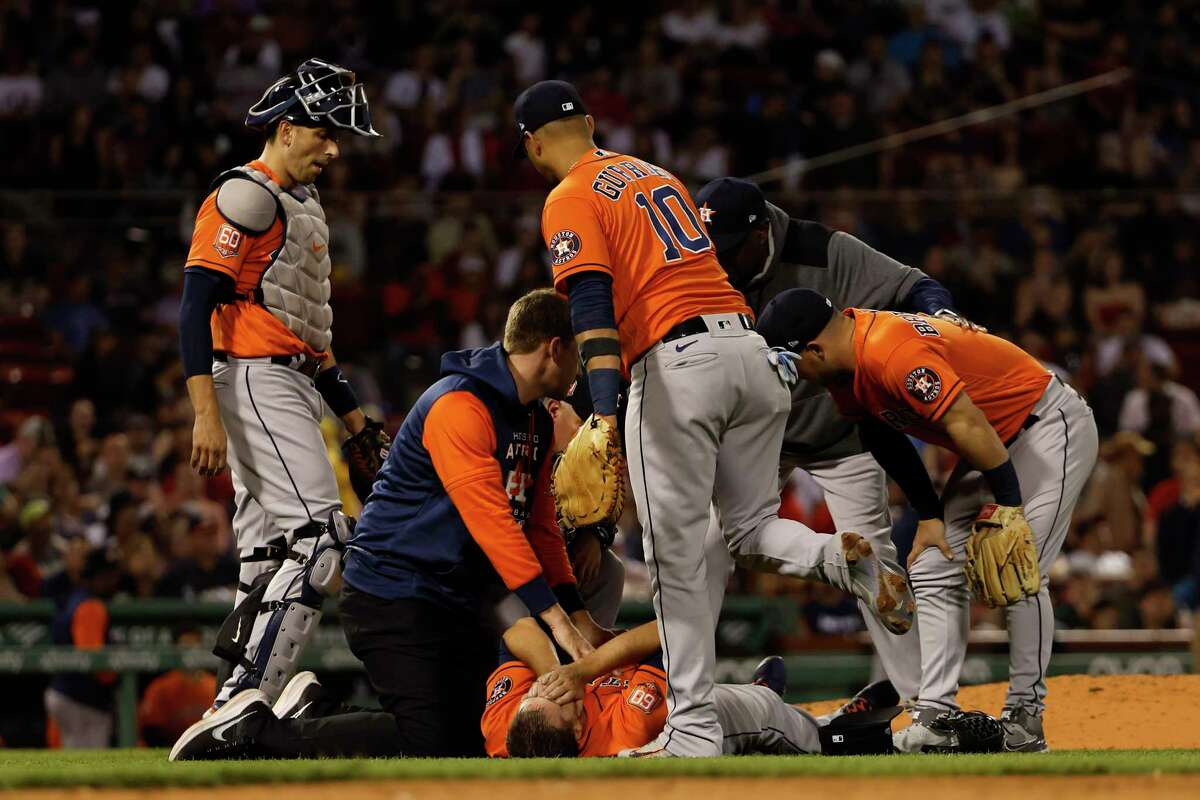BOSTON, MA - MAY 16: Pitcher Jake Odorizzi #17 of the Houston Astros lies on the ground after being injured trying to get off the mound to cover first base on a ground out by Enrique Hernandez of the Boston Red Sox during the sixth inning at Fenway Park on May 16, 2022 in Boston, Massachusetts. Odorizzi left the game on a stretcher.