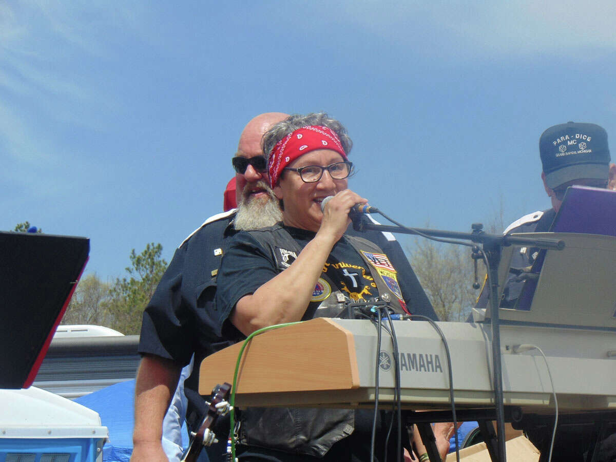 Thousands of motorcycle enthusiasts descended on Baldwin, May 13-15, for the 50th anniversary of the Blessing of the Bikes. Above, AMVETS Post No. 1988 Commander Marlene Gaitin speaks during the Blessing on Sunday. AMVETS will take over the event next year, making it all local. 