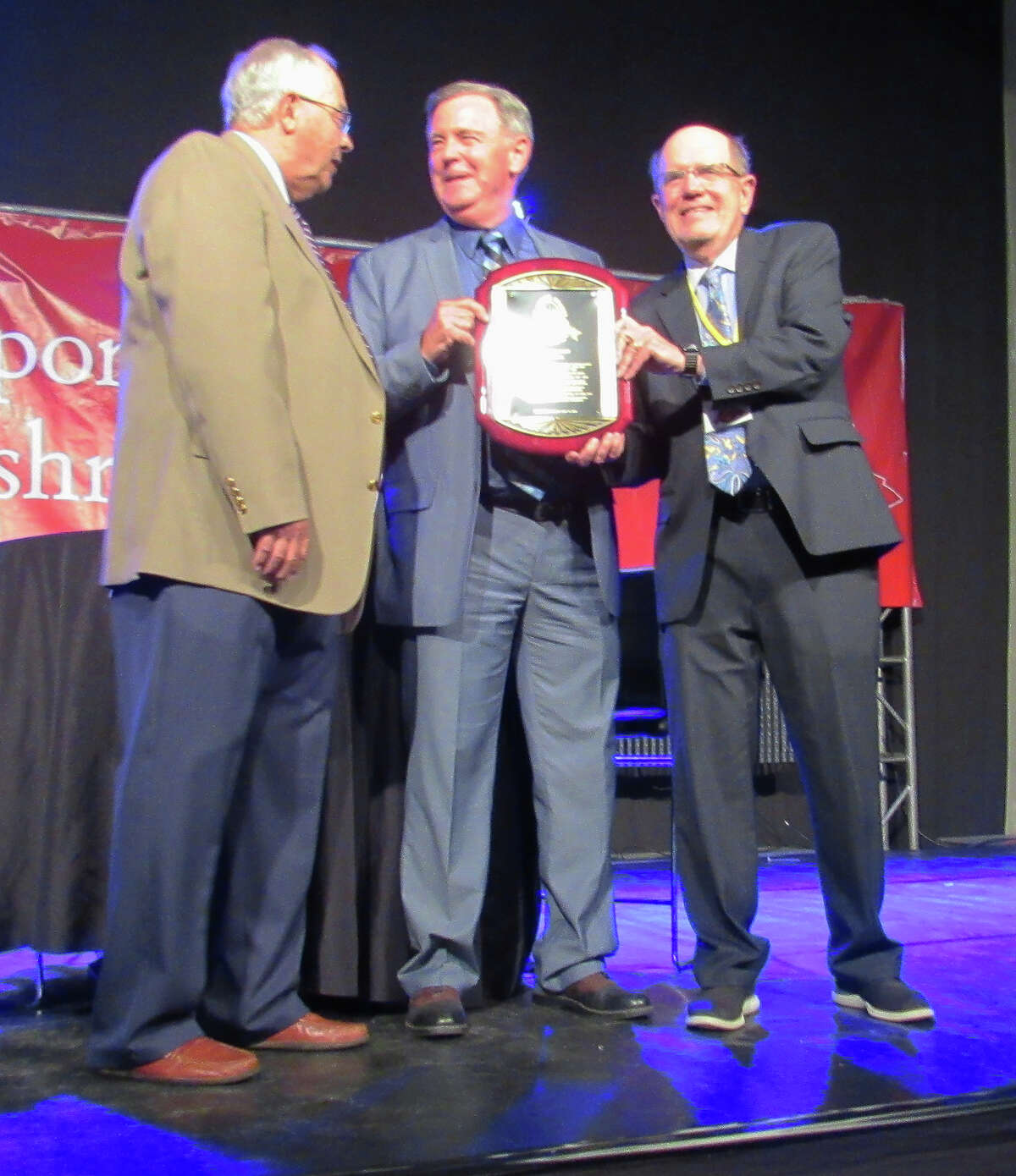 Former Marquette baseball coach Greg DeCourcey, middle, with Tim Moore, left, president of the St. Louis Sports Hall of Fame, and former Alton Telegraph sports editor Steve Porter on Monday night after DeCourcey was inducted during the Illinois Enshrinement Dinner at Gateway Classic Cars in O’Fallon.