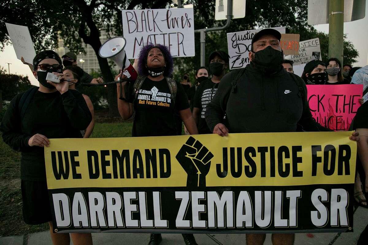 Amyrose Felan, from left, Camille Wright, and Hector Rodriguez lead a group of supporters of Darrell Zemault Sr., as they demand justice for him outside Public Safety Headquarters downtown, where they marched from the Bexar County Courthouse, on Saturday, Sept. 26, 2020.