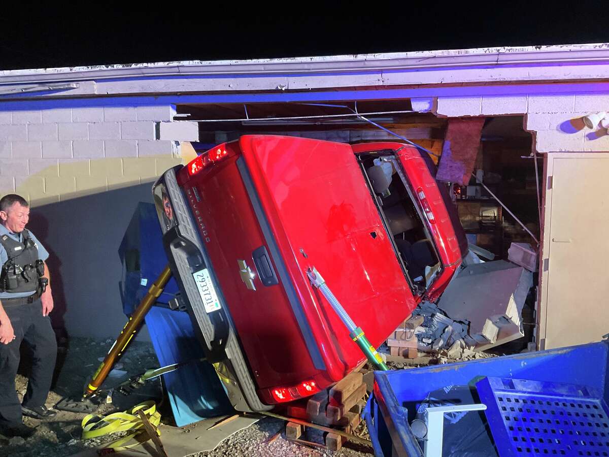 A red Chevrolet Silverado lays in the rubble of Makers Market in Maryville. A 65-year-old man was air lifted to St. Louis University Hospital after crashing the pickup into the building.