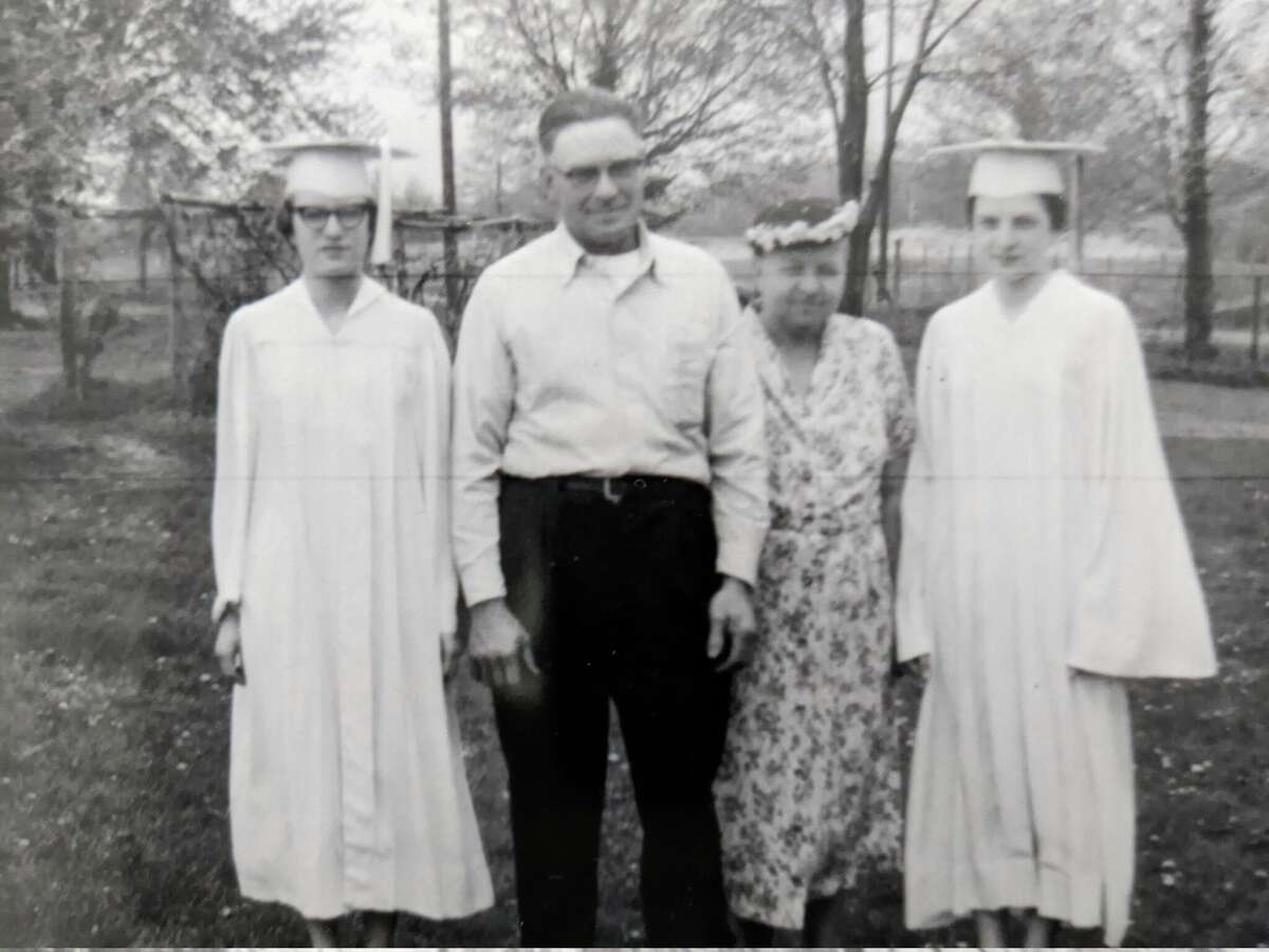 Mary Ann and Bernadine Bartos were in the last graduating class from Midland Senior High School on Rodd Street in 1956. Bernadine, left, stands by her dad and mother, Henry and Frances Bartos, with Mary Ann on the right. The sisters graduated in the top 10% of their class.