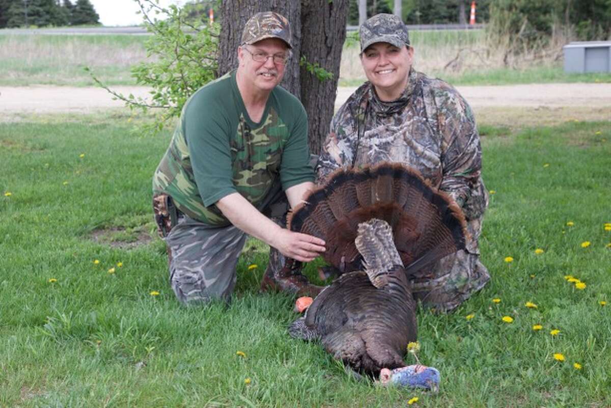 Kimberly Patterson of Roseville (right) successfully bagged a dandy gobbler during the recent BOW Turkey Hunting Workshop in the Thumb, which was called in by her mentor, Allan Benedetti (left).