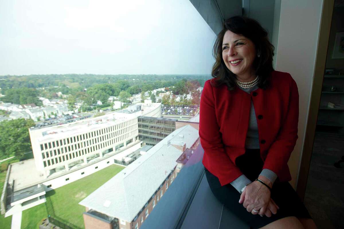 Stamford Health President and CEO Kathleen Silard looks out a window of Stamford Hospital overlooking the former hospital in Stamford, Conn.