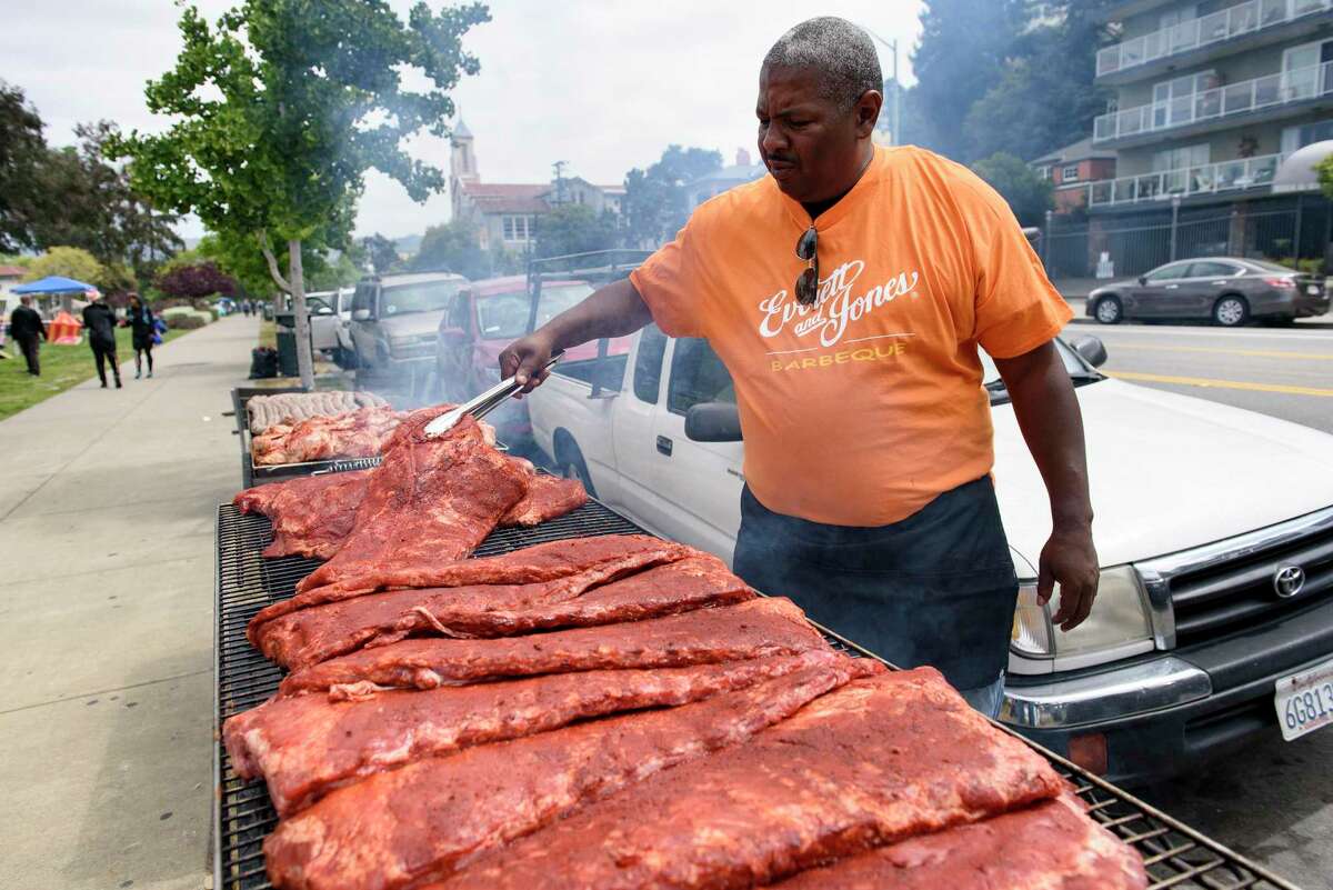 Lamont Payton of Everett & Jones BBQ tends to his grills at Lake Merritt. Everett & Jones is opening a new location in Sonoma County.