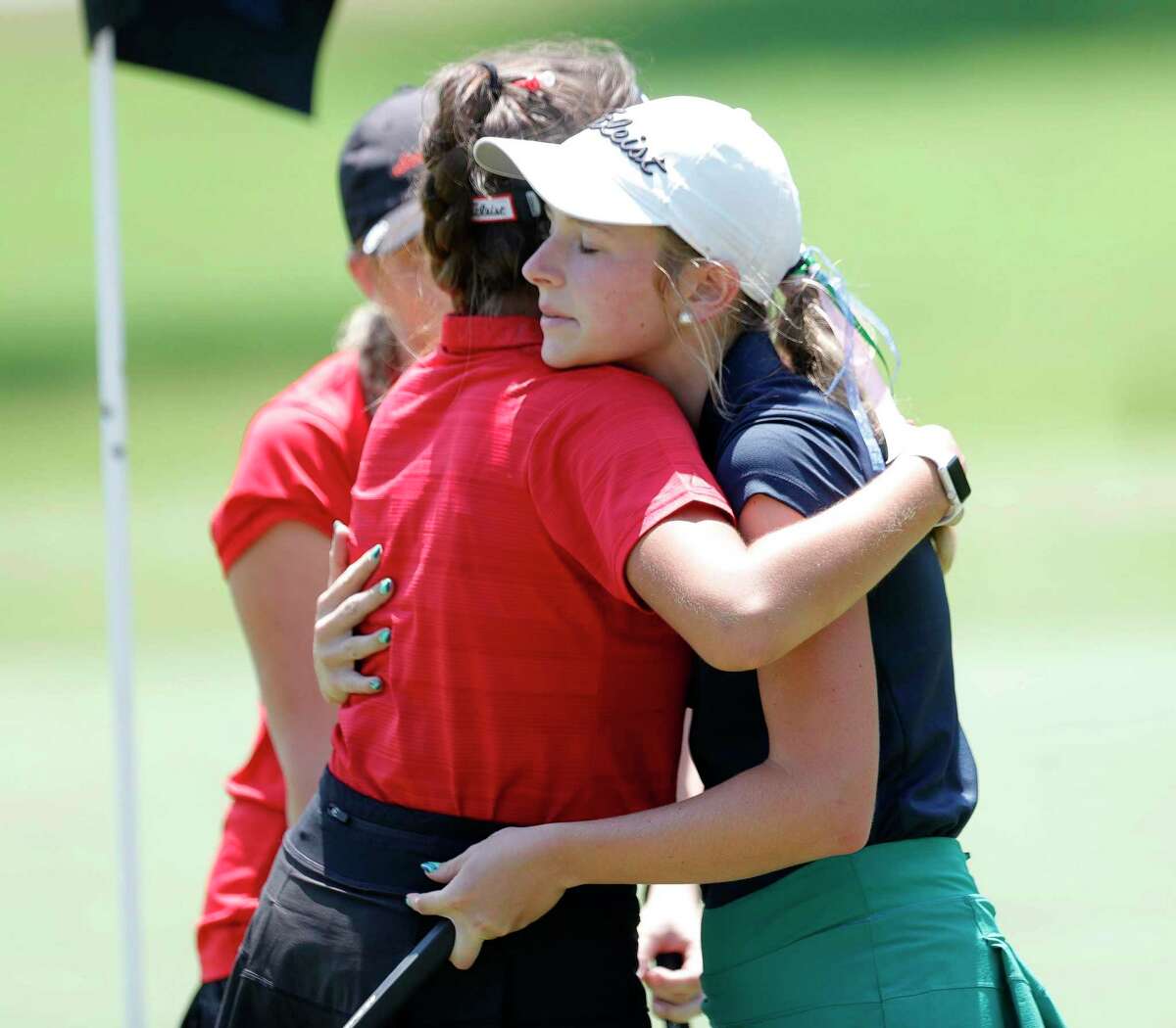 Gracie Heinle of College Park, right, hugs Veronica Expositio after finishing the final round of the Class 6A UIL State Golf Championship at Legacy Hills Golf Club, Tuesday, May 17, 2022, in Georgetown.