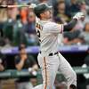 San Francisco Giants' Curt Casali follows the flight of his solo home run off Colorado Rockies relief pitcher Ty Blach in the third inning of a baseball game, Monday, May 16, 2022, in Denver. (AP Photo/David Zalubowski)