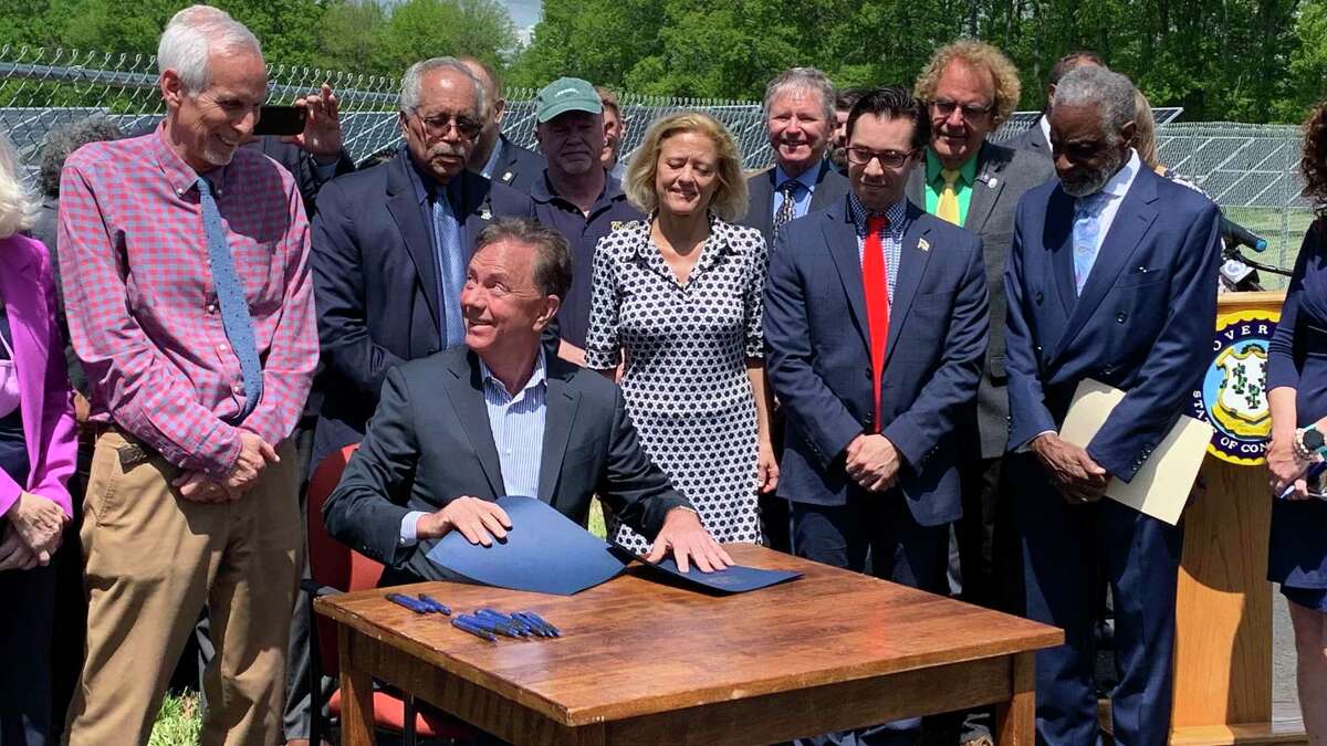 Gov. Ned Lamont signs legislation Tuesday that codifies his plan to produce all of the state's power needs from zero-carbon sources by 2040.
