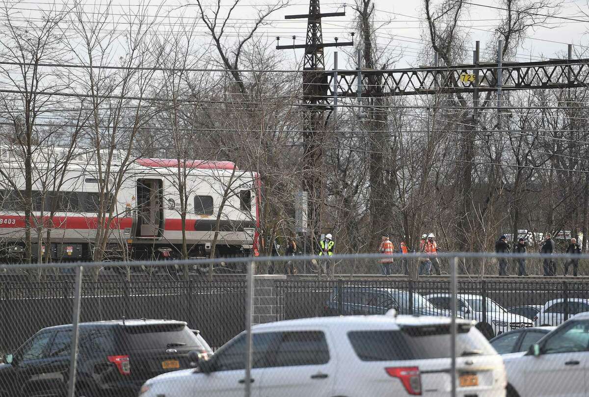 A Metro North train waits on the tracks as police investigate the scene after a person was struck and killed on the tracks near Commerce Drive in Fairfield, Conn., on Wednesday, March 23, 2022.