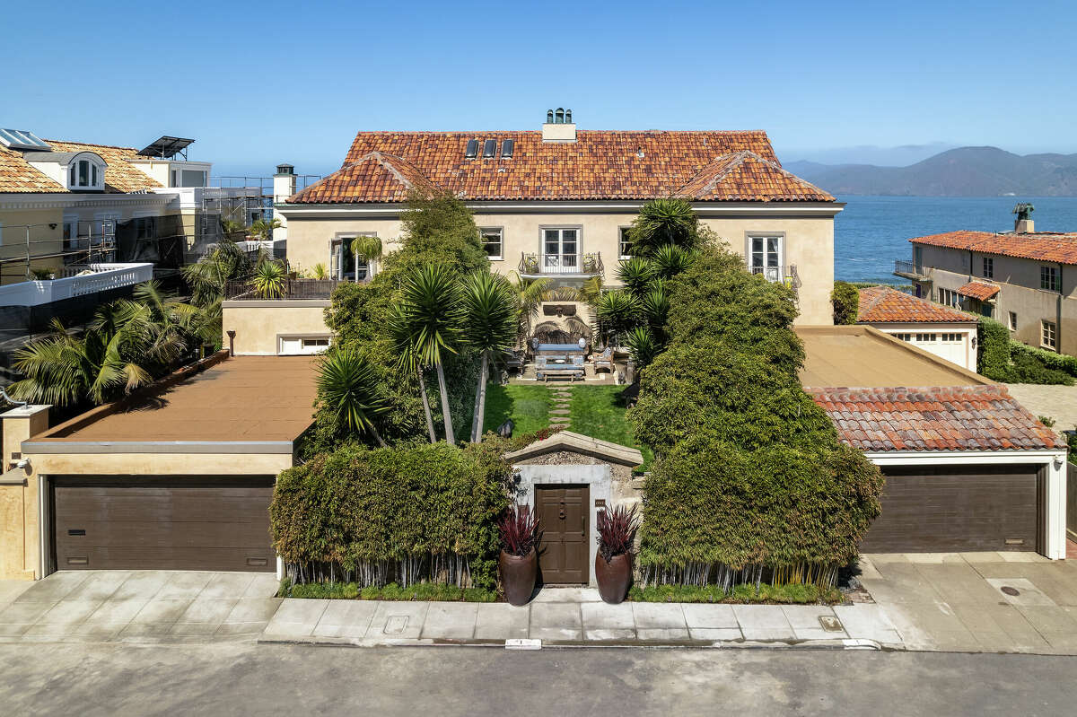 Along with the huge mansion are two separate garages which flank the home from the street.   