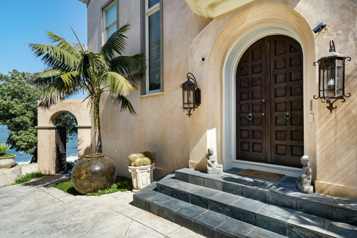 The entrance to the home is grand enough to frame the mansion as well as the sea that it's backdrop.   