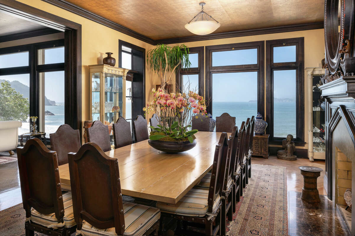 A formal dining room offers dramatic wood and glass frames for the views.   