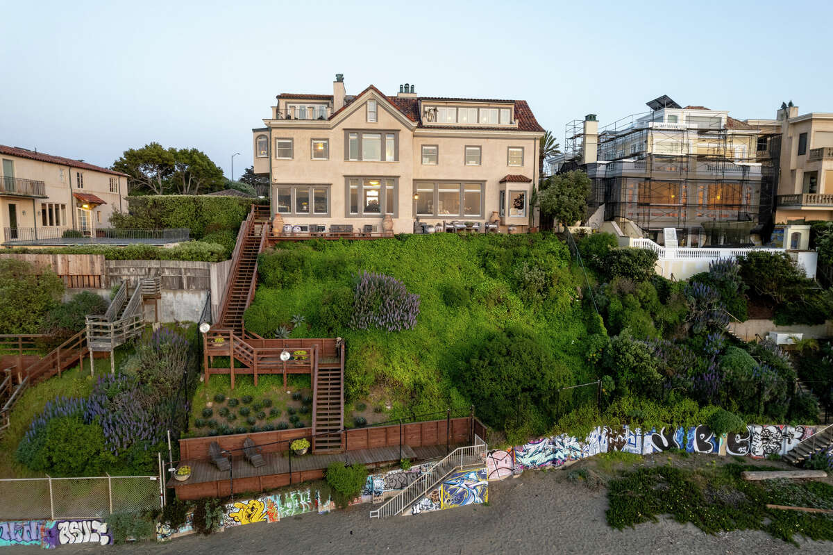 The home has an iconic placement on the bluff overlooking the water. These stairs lead down to the beach.
