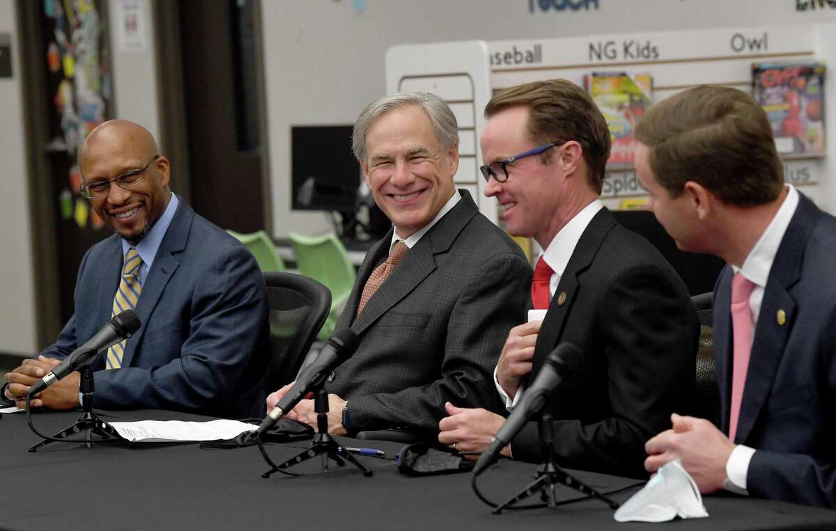 From left, Hamshire-Fannett Superintendent Dwaine Augustine, Governor Greg Abbott, House Speaker Dade Phelan and Representative Trent Ashby talk about a new broadband access bill coming before the state legislature during a press conference at Hamshire-Fannett Elementary School Monday. Photo made Monday, March 29, 2021 Kim Brent/The Enterprise