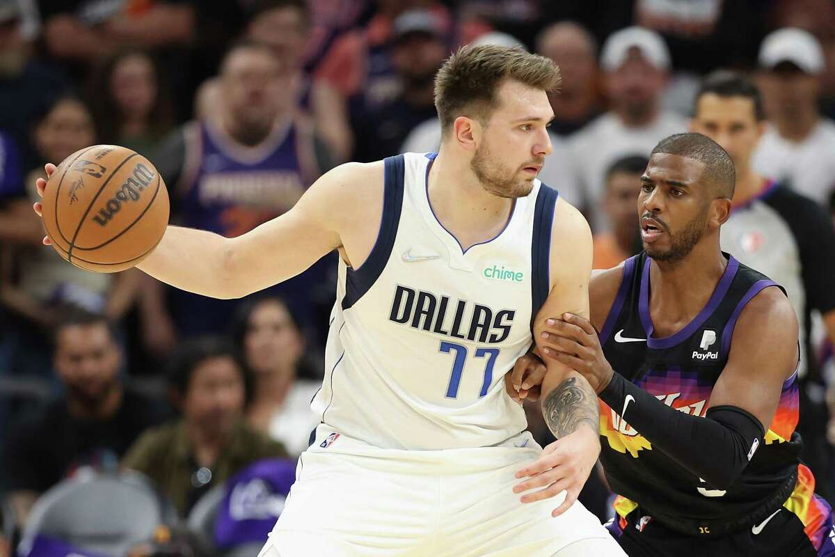 PHOENIX, ARIZONA - MAY 15: Luka Doncic #77 of the Dallas Mavericks handles the ball against Chris Paul #3 of the Phoenix Suns during the first half of Game Seven of the Western Conference Second Round NBA Playoffs at Footprint Center on May 15, 2022 in Phoenix, Arizona. NOTE TO USER: User expressly acknowledges and agrees that, by downloading and or using this photograph, User is consenting to the terms and conditions of the Getty Images License Agreement. (Photo by Christian Petersen/Getty Images)