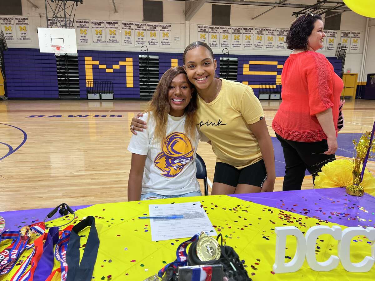 Midland High track athlete, seated, poses after signing with Dodge City Community College on 5/17/2022.