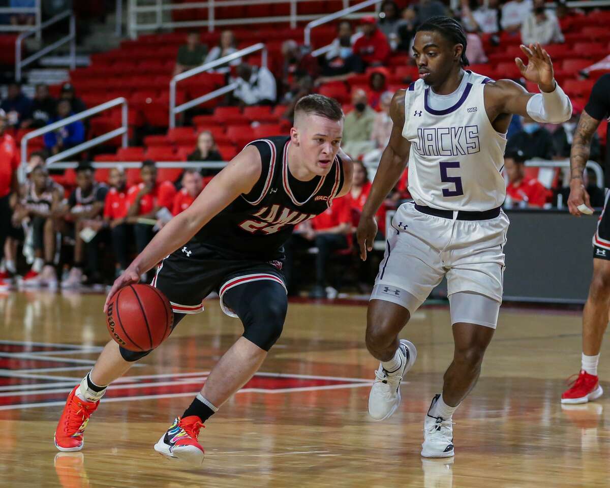 Brock McClure dribbles the ball during a game against SFA. He'll soon be in Jamaica with a basketball outreach program. 