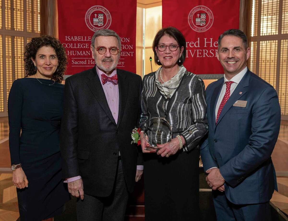 Maureen Ruby was honored as the inaugural Isabelle Farrington Endowed Chair of Social, Emotional and Academic Leadership during a ceremony at the Guest House on the Sacred Heart University's West Campus. Pictured, from left, are Provost Robin Cautin, President John Petillo, Maureen Ruby and Vice Provost for Strategic Partnerships & Dean of the Isabelle Farrington College of Education & Human Development Michael Alfano. Photo by Mark F. Conrad 4/8/22