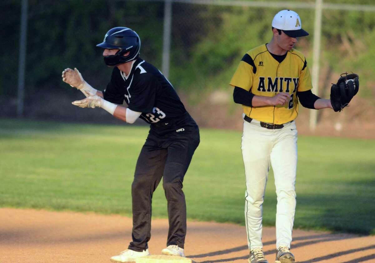 Spencer Misenti of Xavier celebrates after hitting a double. Paul Canalori is the Amity shortstop. Tuesday, April 17, 2022.