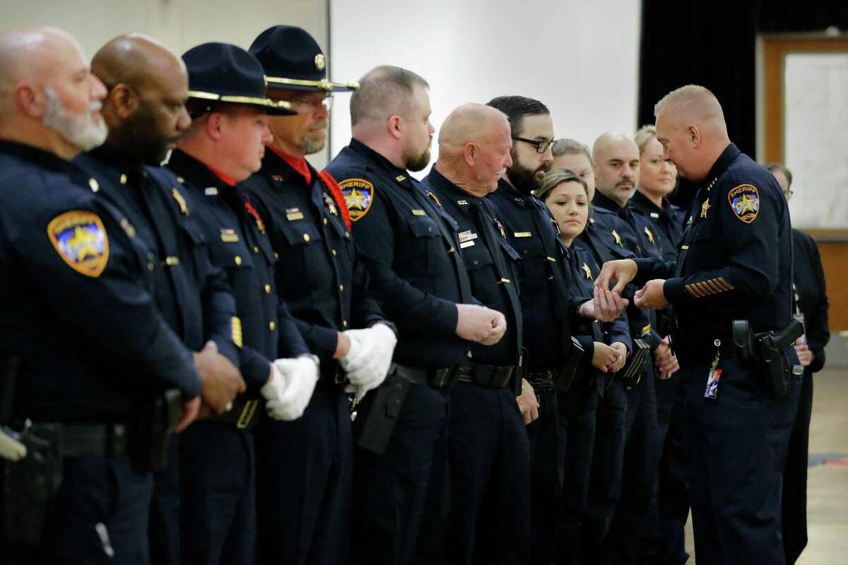 Sheriff Rand Henderson, right, hands out awards to members of the Homicide and violent grimes unit during the annual Montgomery County Sheriffs Office Promotion, Recognition, and Award Ceremony held at The Lone Star Convention & Expo Center Tuesday, May 17, 2022 in Conroe, TX.