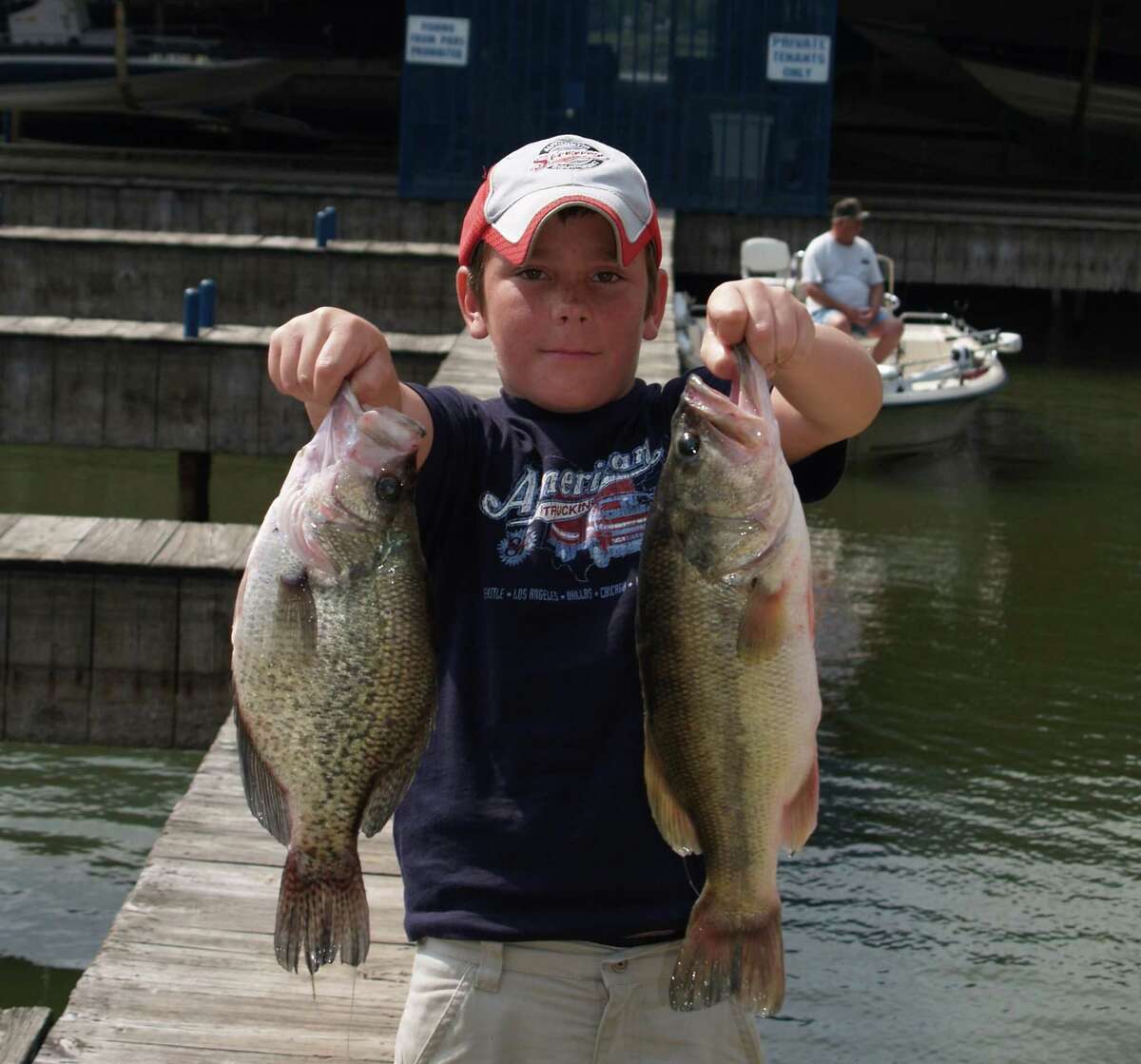 The young man that caught these nice crappie and bass will in years to come have the basis for some tall tales.