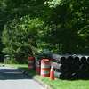In this file photo, pipes for a water main replacement, by a contractor for Aquarion Water Company, are seen on on Eleven Levels Road in Ridgefield, Conn.