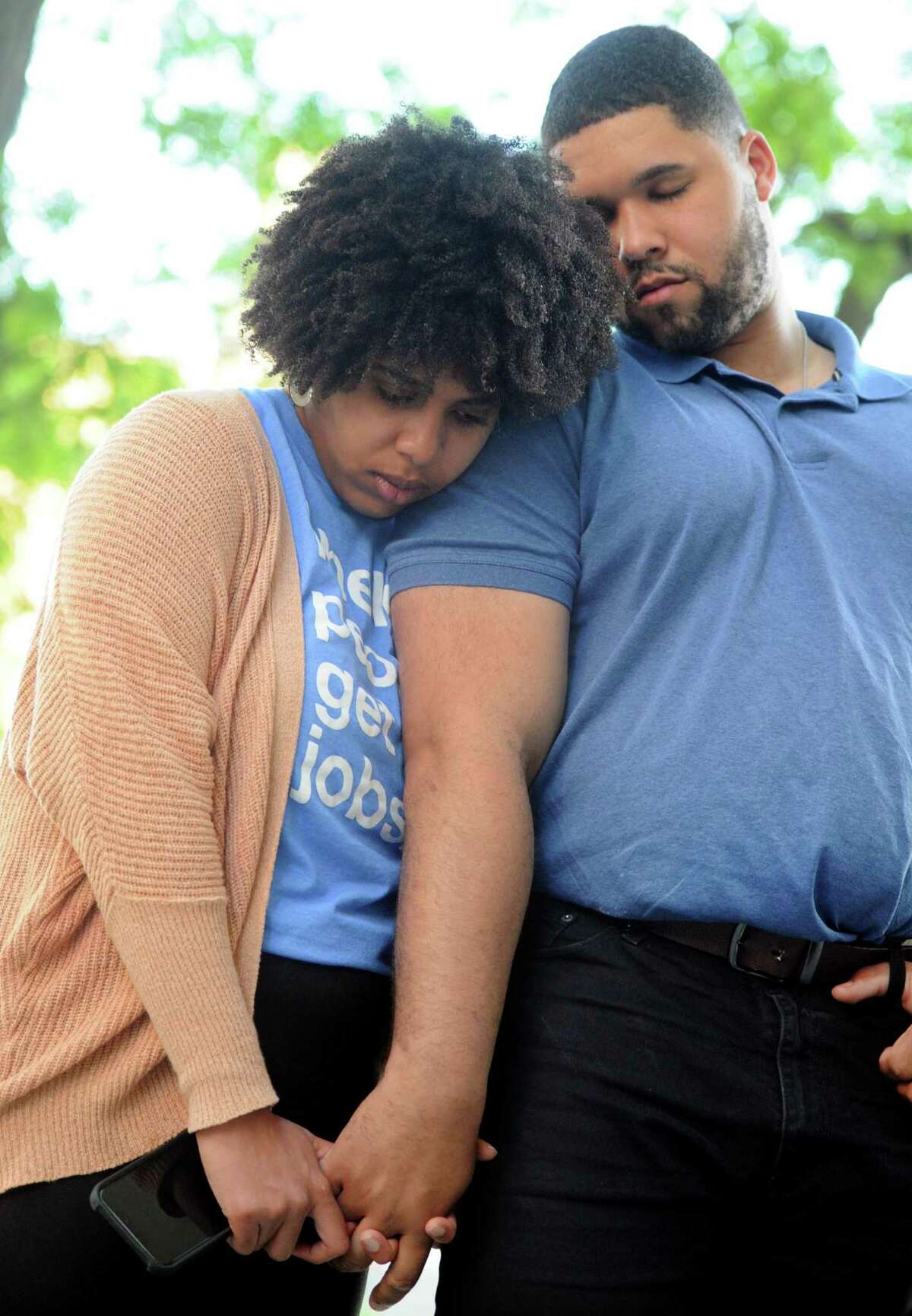 Ayanis Lindo and her boyfriend Hubert Delany bow their heads in prayer during the vigil.
